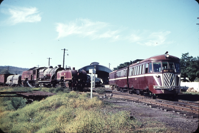 108197: Mount Morgan Up Goods Beyer Garratt 1006 and Up Rail Motor RMd 91 leading