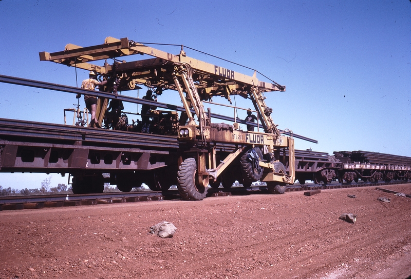 111980: Goldsworthy Railway Shay Gap Extension Mile 97.5 Straddle Crane lifting rails from Steel Train
