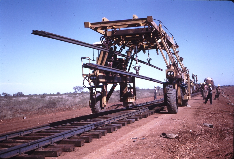 111981: Goldsworthy Railway Shay Gap Extension Mile 97.75 Straddle Crane moving Rails forward No 5 on Steel Train in background