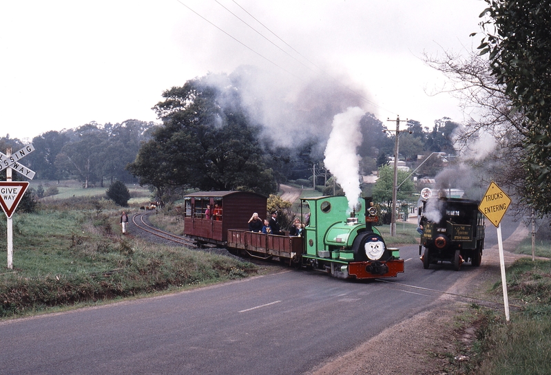 118976: Gembrook Main Road Level Crossing Peckett 1711 on first train to Orchard Road