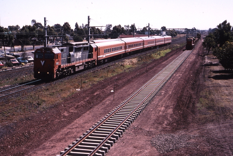 119571: Laverton 8256 Up Passenger from Warrnambool N 452 and in distance T 373 on rail train at head of steel