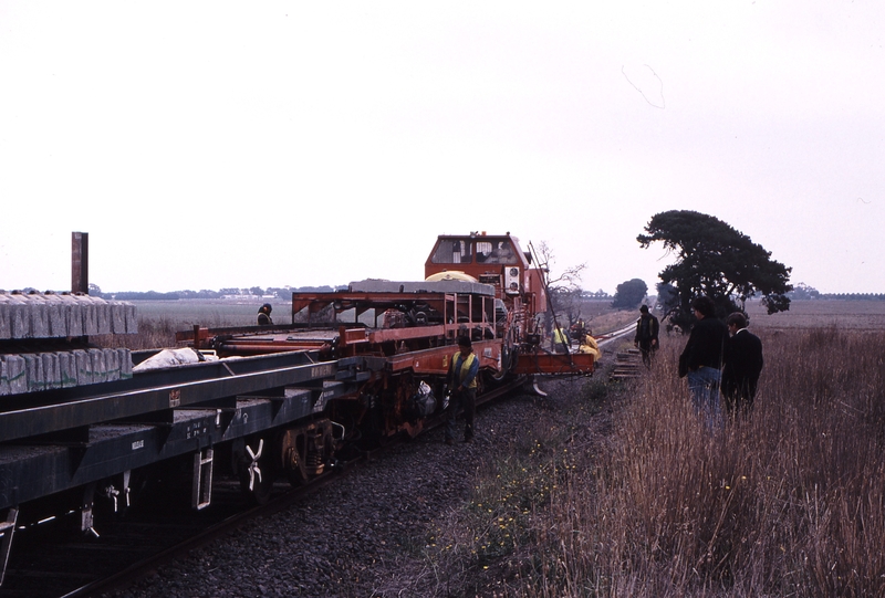 119839: km 86.5 Gheringhap - Inverleigh J Hollands Tracklaying Machine Looking West Right Peter Matiatavich and John Sutton
