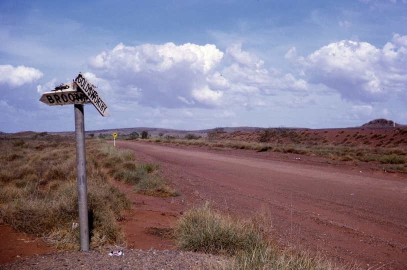 133370: Junction North West Coastal Highway and road to Goldsworthy WA Railway embankment in right background
