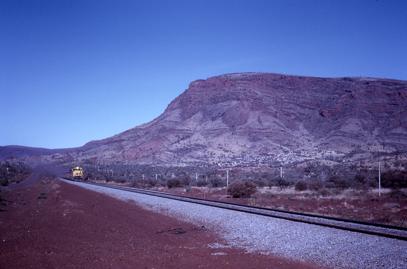 133374: Mount Tom Price WA Loaded Ore Train in distance Mount Nameless in background