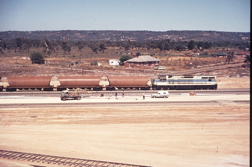 109887: Forrestfield Opposite Locomotive Depot Up Grain L 2xx House behind train is site office for Loco Depot construction