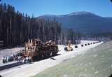 110495: Flathead Tunnel MT 2 Miles West Morrison-Knudsen Tie Machine at work on BN ex GN deviation for Libby Dam