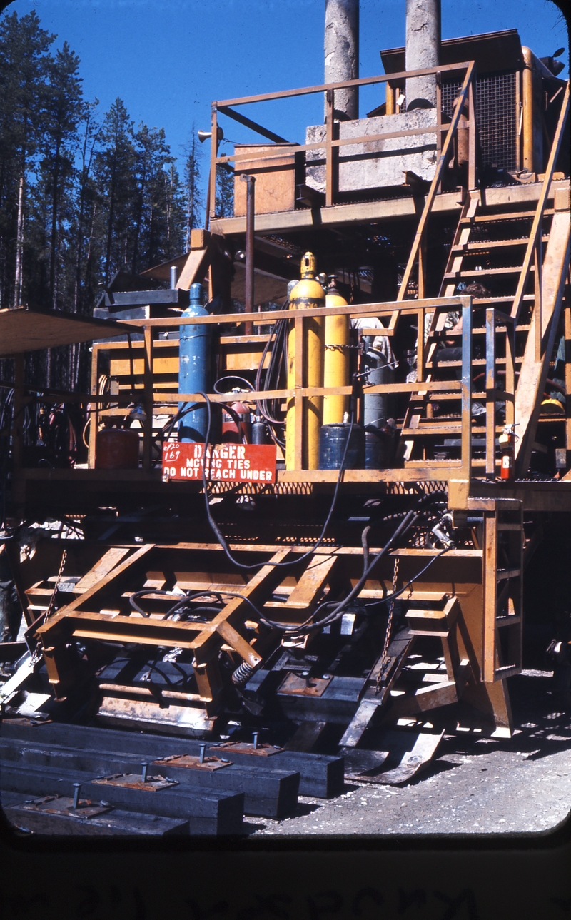 110496: Flathead Tunnel MT 2 Miles West Morrison-Knudsen Tie Machine at work on BN ex GN deviation for Libby Dam