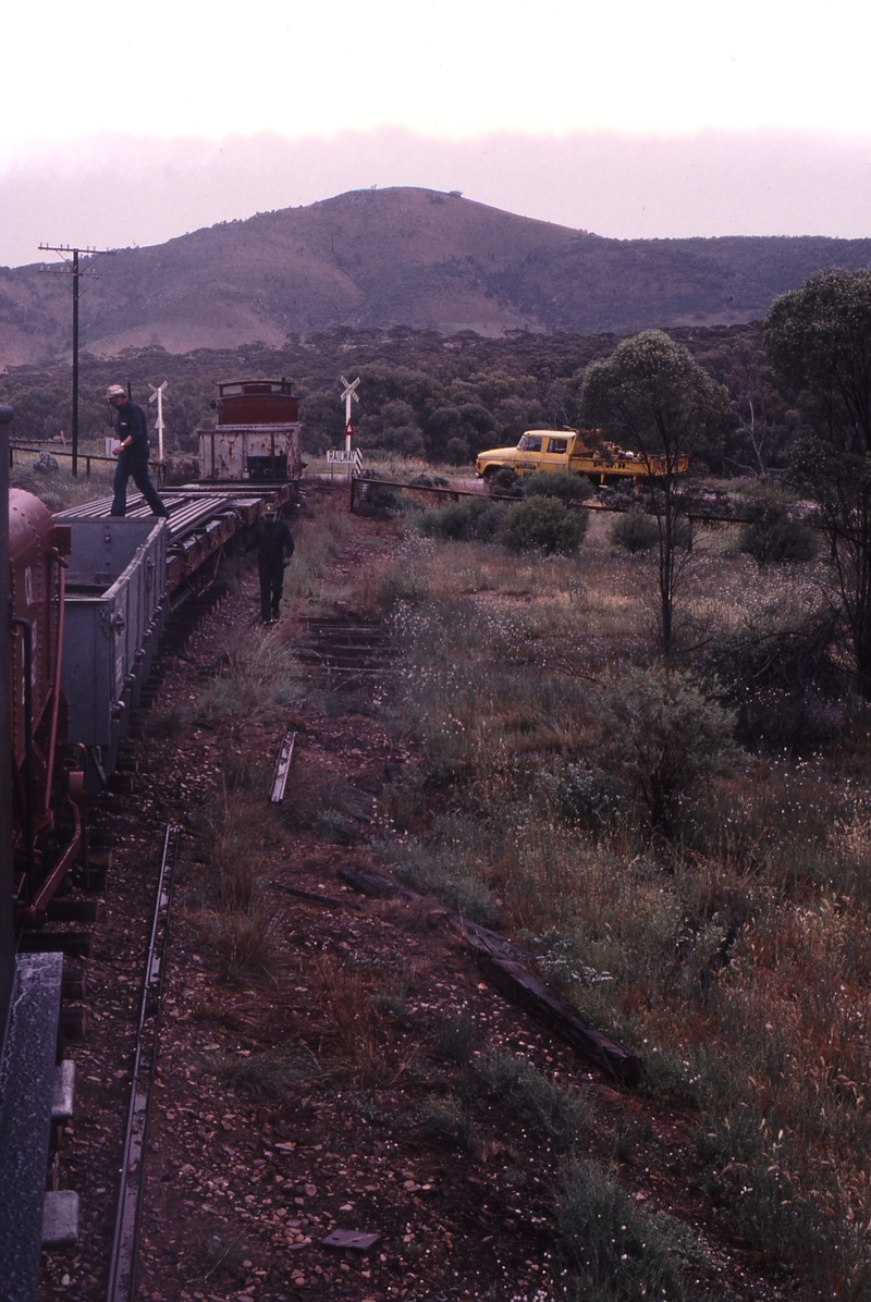 122777: Level Crossing midway in Woolshed Flat Saltia Section Southbound Work Train T 186 Unloading rails