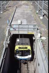 128213: Federation Square MTrain Comeng Suburban Train emerging from Nothern Lines' Ramp