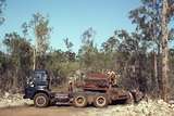 400115: Groote Eylandt NT BHP Alanyangula Gorge Quarry unloading Traxcavator from AEC lowloader