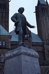 401199: Ottawa ON Canada Statue of Thomas D'Arcy McGee at rear of Houses of Parliament